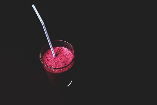 Blueberry smoothie with fresh berries, chia seeds and banana for breakfast on dark background, selective focus