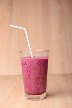 Blueberry smoothie with fresh berries, chia seeds and banana for breakfast on rustic wooden background, selective focus