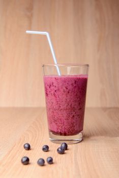 Blueberry smoothie with fresh berries, chia seeds and banana for breakfast on rustic wooden background, selective focus