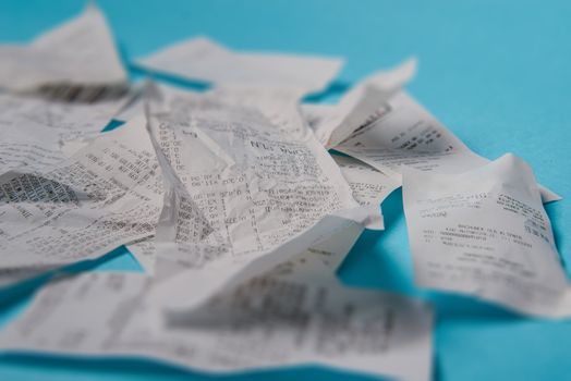 Pile of shopping receipts on a blue background
