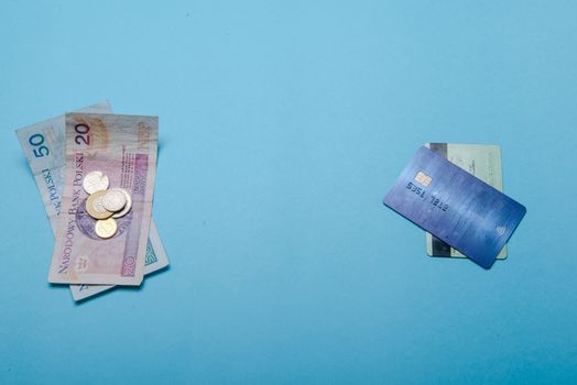 Credit or payment cards and money isolated on blue background