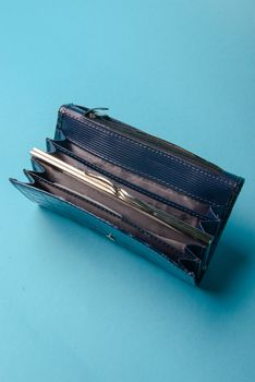 Blue ladies leather purse on a blue background