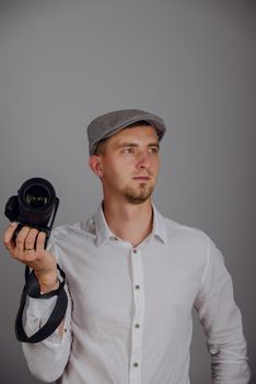 Young man using a professional camera in studio