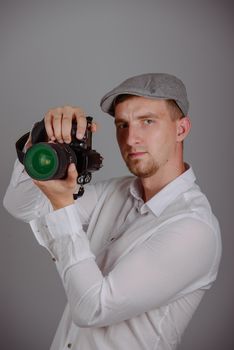 Young man using a professional camera in studio