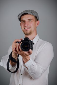 Young man using a professional camera in studio