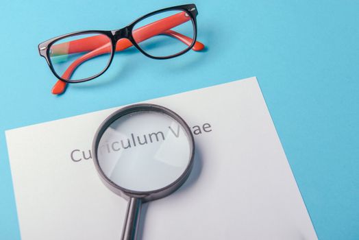 Curriculum vitae written on an blank white paper on blue background