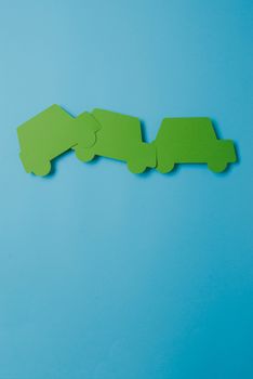 paper green cars figure. top view on blue background
