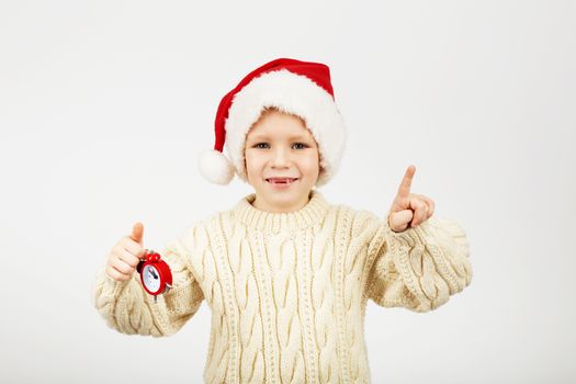 Portrait of happy joyful beautiful little boy wearing Santa hat against white background. New Year and Christmas concept