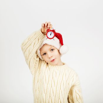 Portrait of happy joyful beautiful little boy wearing Santa hat against white background. New Year and Christmas concept