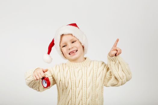 Portrait of happy joyful beautiful little boy wearing Santa hat against white background. New Year and Christmas concept