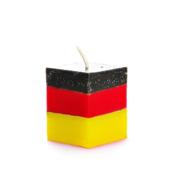 Decorative Handmade candle isolated on white background. Cube-shaped souvenir candle as German state flag and country symbol. Rectangular cube block shaped candles.