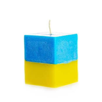 Decorative Handmade candle isolated on white background. Cube-shaped souvenir candle as Ukraine state flag and country symbol. Rectangular cube block shaped candles.