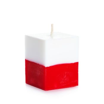 Decorative Handmade candle isolated on white background. Cube-shaped souvenir candle as Polish state flag and country symbol. Rectangular cube block shaped candles.