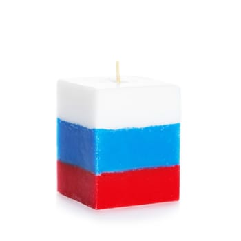 Decorative Handmade candle isolated on white background. Cube-shaped souvenir candle as Russian tricolor state flag and country symbol. Rectangular cube block shaped candles.