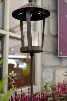 rusty lamp post for lamp with a candle placed in a flower pot