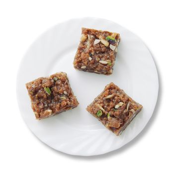 Indian sweets on a plate isolated over white