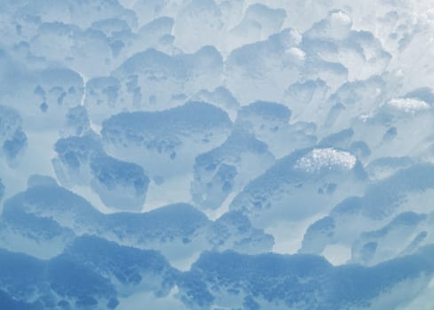 Block of blue smooth melting ice, close-up