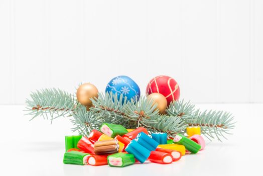 Colorful array of mixed candy with a festive seasonal background.