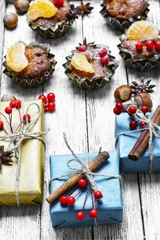 Homemade Christmas cupcakes decorated with cranberries and mandarins
