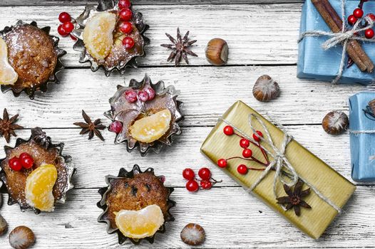 Homemade Christmas cupcakes decorated with cranberries and mandarins