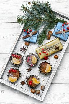 Homemade Christmas cupcakes decorated with cranberries and mandarins