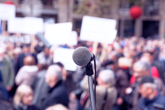 Microphone in focus against blurred protesters