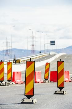 The road is being repaired and blocked with special yellow and red standing signs