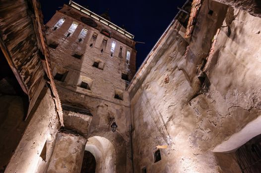 View to the watch tower at night in Sighisoara town, Romania