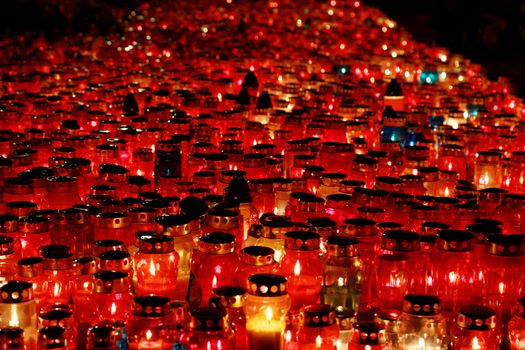 thousands of burning candles on the cemetery 