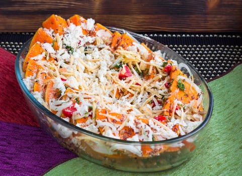 Vegetarian salad of orange pumkin, mixed vegetables, herbs and cheese