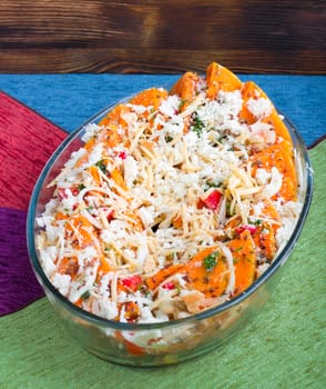 Vegetarian salad of orange pumkin, mixed vegetables, herbs and cheese