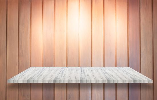 Top of white wooden shelf with spot light on wooden wall background, stock photo