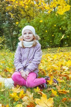 Cute girl under falling yellow leaves dreaming