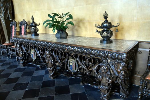 Old table sculptured with heads of lion and coat of arms.