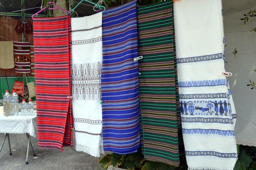 Cretan material of several colors hung on a thread.
