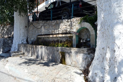 Old stone fountain in the campaign on the Cretan