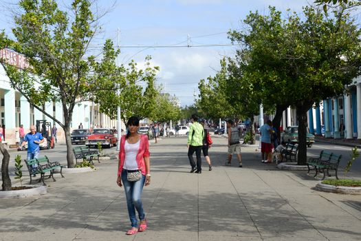 Cienfuegos, Cuba - 18 january 2016: People walking in front of colonial architecture at the old town of Cienfuegos, Cuba