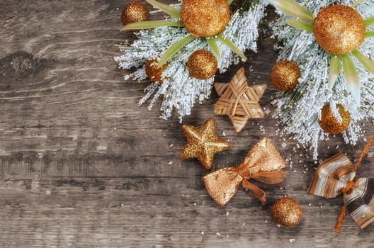 Christmas composition with warm colours. The various decorations on old wooden background. A place for a label.