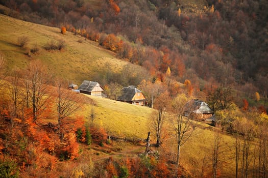 Fall in mountain village. Alpine October scene.