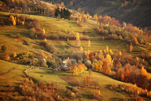 Fall in mountain village. Alpine October scene.