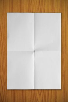 Blank white paper on a wooden background