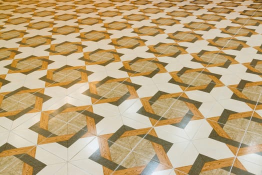 Floor tiled with a patterns like parquet