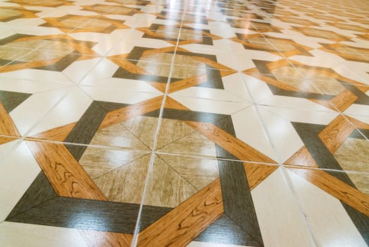 Floor tiled with a patterns like parquet