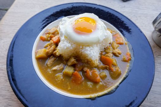 Indian food: beef with Fried Egg on the rice in the dish. horizontal view from above.