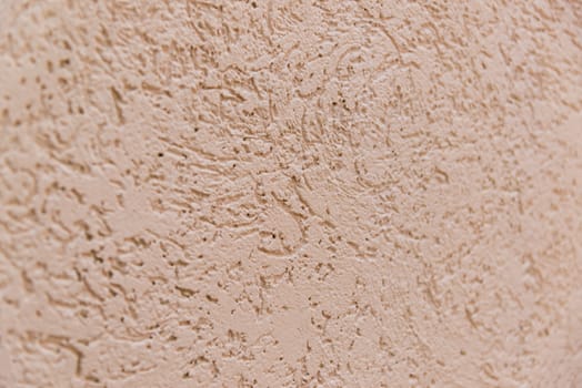 Background from decorative facing plaster on the pink wall