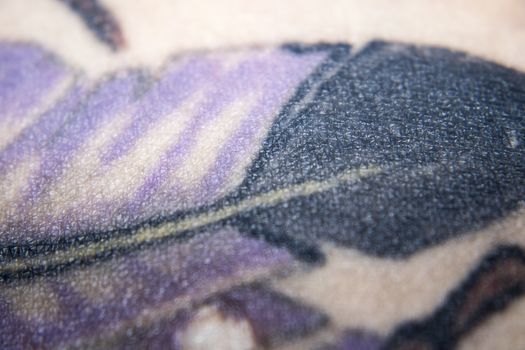 purple black color tattooed skin detail macro photo