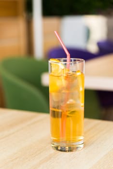 A glass of lemonade on a table in a cafe