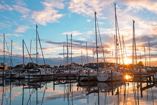 Boats in the harbor from Katwoude in the Netherlands at sunset