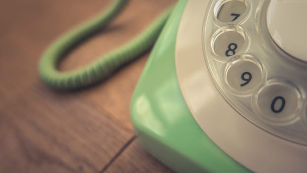 Detail Of A Pastel Green Vintage Rotary Telephone On A Rustic Wooden Table With Copy Space