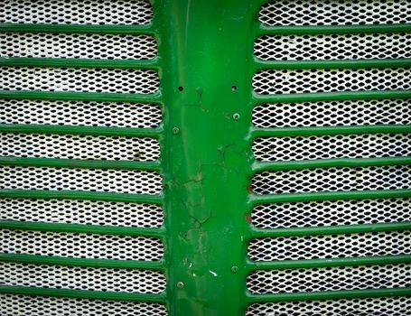 background Green front mask of the engine of the tractor